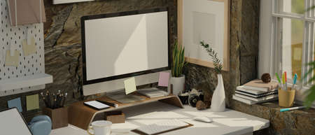 Modern loft office studio workspace interior with pc computer white screen mockup and office...
