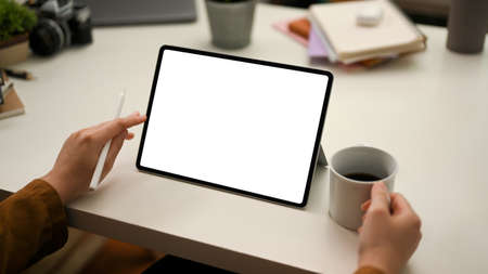 Cropped shot, Female entrepreneur checking and analyses stock market data on digital tablet...