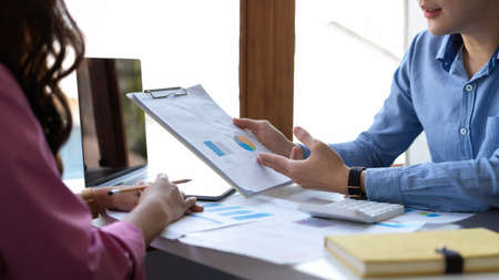 Cropped image, Male financial advisor explains data report and giving an investment recommendations...