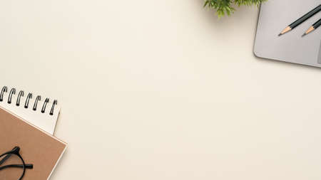 Simple white workspace with copy space for product display, stationery and laptop mockup. top view