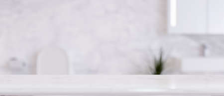 White marble bathroom countertop with empty space for product display over blurred luxury white...