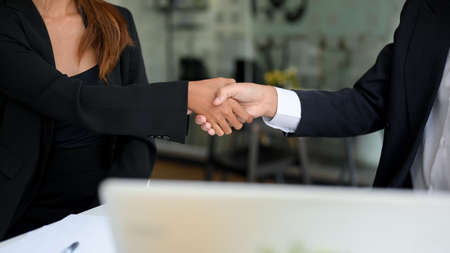 Businessman and businesswoman are shaking hands. Success, partnership, greeting, congratulations.