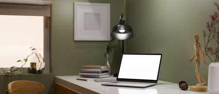 Modern stylish workplace interior with portable notebook laptop white screen mockup, modern table...
