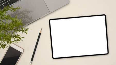 Top view, Digital tablet touchpad white screen mockup, pencil, smartphone black screen, laptop and...
