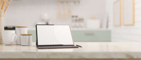 Tablet touchpad white screen mockup, coffee mug, sugar bottle and copy space for product display on white marble kitchen countertop against blurred kitchen background. 3d rendering, 3d illustrationの写真素材