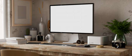 Minimal cozy rustic workspace interior with modern computer white screen mockup, modern gadget, and...