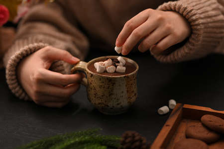 Close-up, image, Woman enjoy having a hot chocolate milk with marshmallow in her cold day at home.