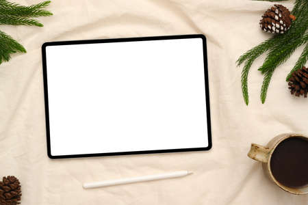 Top view, Digital tablet touchpad white screen mockup on white background with stylus pen, coffee...