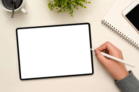 Overhead shot, Female hands using stylus pen designing her graphic design on tablet touchpad screen.