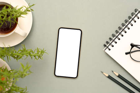 Top view, Flat lay, Modern workspace with cellphone or smartphone blank screen mockup, eyeglasses,...