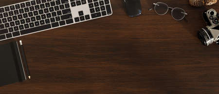 Top view, Flat lay, Modern office workspace with keyboard computer, camera, notebook, eyeglasses,...