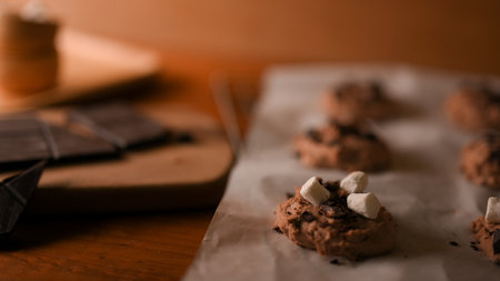 Close-up image, Chocolate chip cookies dough with tiny marshmallow on a baking sheet. Baked pastries