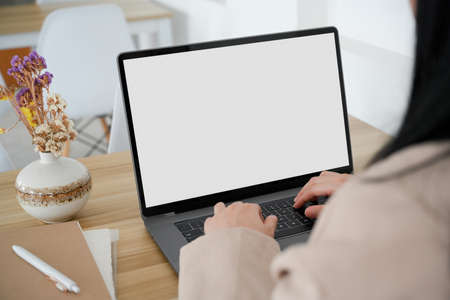 Back side, close-up, Businesswoman is working on laptop computer, doing her online report and...