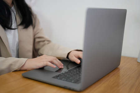 Close-up image, Female freelancer using laptop computer in the coffee shop. Remote working concept.の写真素材