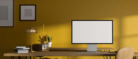Modern stylish creative workspace with desktop computer mockup and accessories on table against yellow wall with frames mockup. 3d rendering, 3d illustrationの写真素材