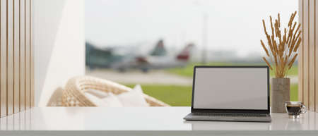 Comfortable and minimal workspace with laptop computer mockup, a cup of coffee, flowers vase and...