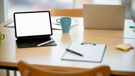 Close-up, Office workspace with portable tablet white screen mockup and wireless keyboard stand on...
