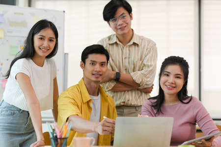 Portrait, A group of Asian young business entrepreneur in the meeting room. Happy team workers...