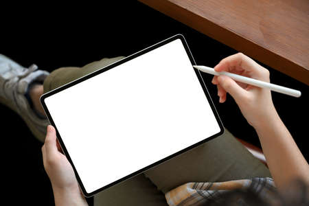 Close-up image, A hipster female freelancer using digital tablet touchpad for design her works....