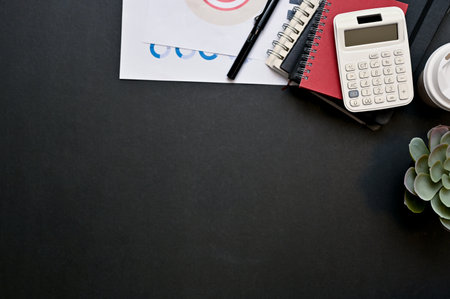 Black workspace background top view with business work equipments and copy space. top view, flat lay