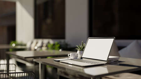 Modern stylish co working space in coffee shop interior design with portable laptop computer mockup...