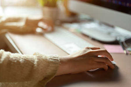 Female office worker or business employee sits at her office desk, working, managing her task on...