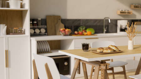 Minimal wooden dining table with a cup of coffee, breads in basket and decor over blurred modern...