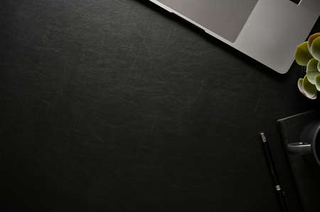 Modern black office desk workspace with notebook laptop, decor plant, accessories and copy space for display your text. top view, flat layの写真素材