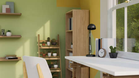 Comfortable home working room interior design with working table against the window, wooden...