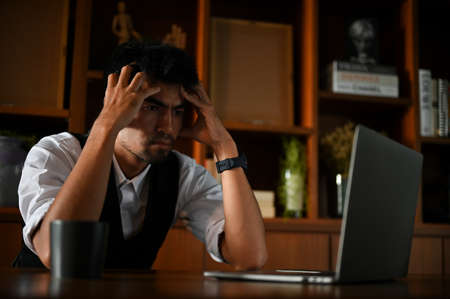 Stressed and serious Asian businessman or male executive manager pensive thinking about his business...