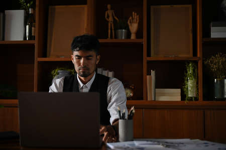 Professional asian businessman or male executive manager in his private office working on portable...