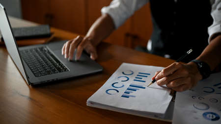 Cropped image, Professional male CEO or businessman working at his office desk, using laptop...
