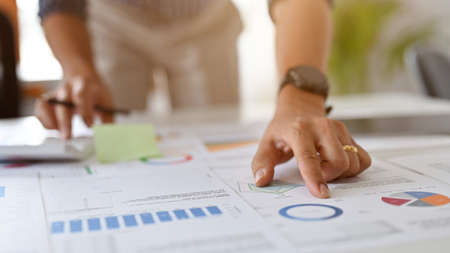 A professional businessman or male financial analyst in the meeting with his coworker, analysing the...