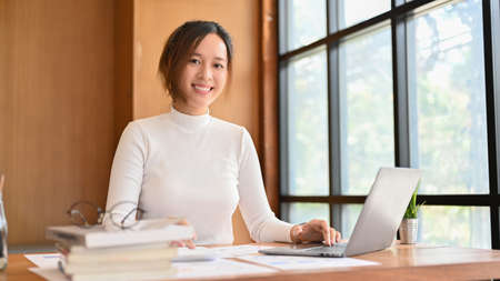 Beautiful charming millennial asian businesswoman or female entrepreneur or female financial...