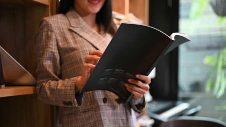 Elegant and beautiful asian woman or businesswoman reading a book in the book store or library....