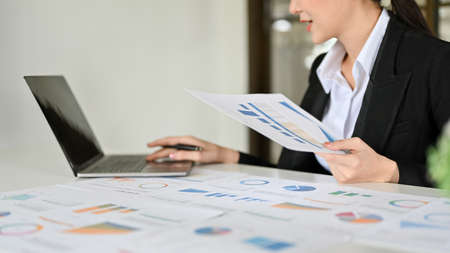 Professional young Asian businesswoman or female financial analysts working on her financial task,...