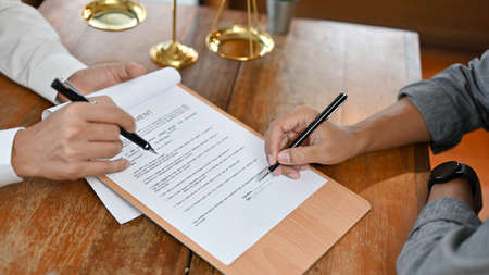 Top view, A professional male lawyer is counselling his client in the office and giving an agreement...
