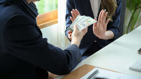 A female lawyer or businesswoman refuses to take a bribe from her client.Â Anti corruption...