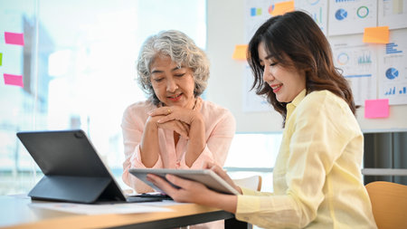 Professional aged Asian businesswoman or female executive manager discussing and consulting with her personal financial consultant in the meeting room.の写真素材