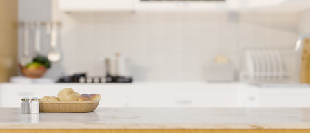 White kitchen islands or countertop with bread basket, seasoning bottles and copy space for your...