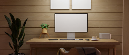 Comfy wooden workspace with blank screen PC desktop computer on wooden table and stationary against...