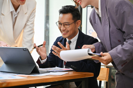 Professional and smart adult Asian businessman or male boss is explaining and showing something on...