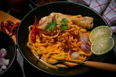 Close-up image, Tasty spicy yellow curry soup with chicken and egg noodles or Khao Soi Kai. Famous Thai food conceptの写真素材