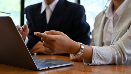 A professional and expert female financial analyst looking the financial data on tablet screen,...