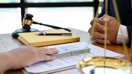 A male client has a formal meeting with his professional male lawyer or business legal consultant to...