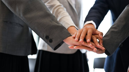 Successful and professional businesspeople put their hands together. Teamwork, celebrating victory, cheer up. cropped imageの写真素材