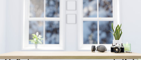 Minimal bright home workplace with headphones, camera, decor and copy space for montage your product display on wood tabletop over blurred background. 3d rendering, 3d illustrationの写真素材