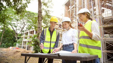 A team of talented young Asian females architects collaborating work with a professional male...