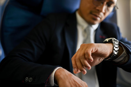 close-up image, Professional and successful Asian businessman checking his watch for the arrival...