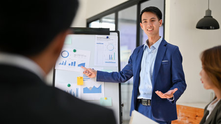 Professional and smart millennial Asian businessman pitching or presenting a new financial...